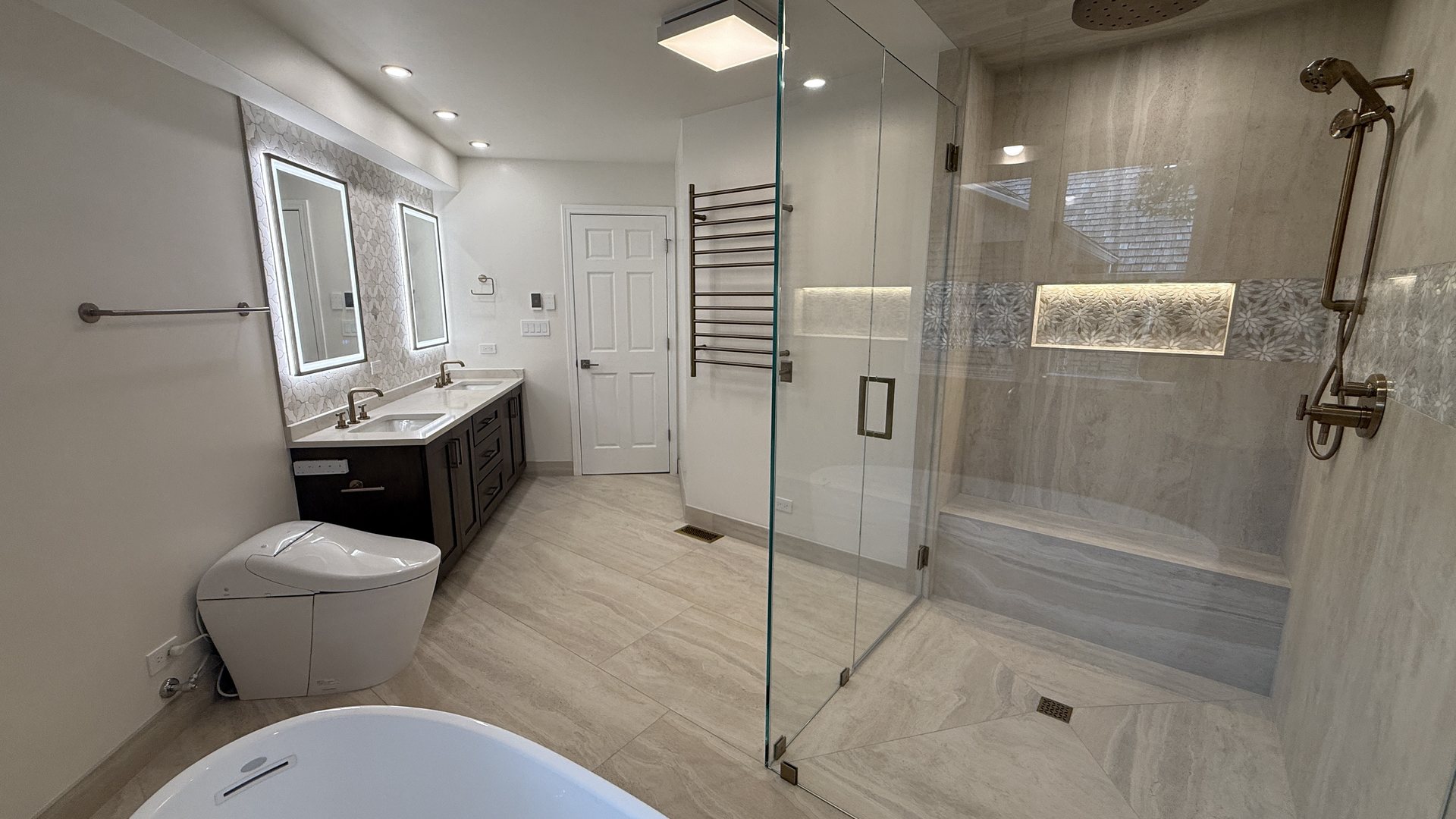 Finished luxury bathroom remodel with glass shower, double vanity, and soaking tub