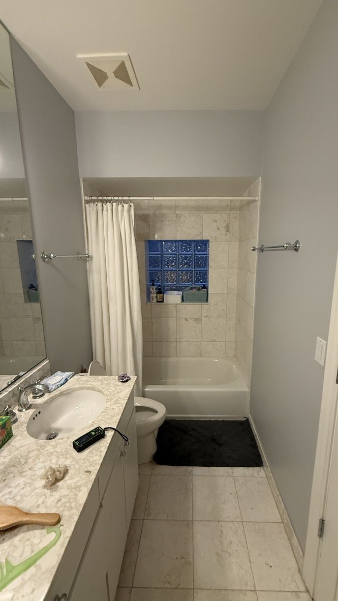 Before renovation: hallway toward tub and shower