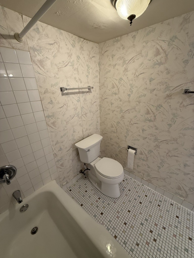 Before renovation: original toilet corner with wallpaper walls