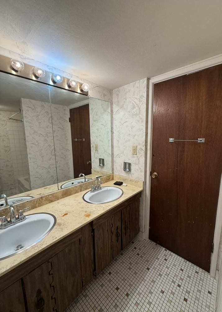 Before renovation: original double vanity with dark wood cabinets