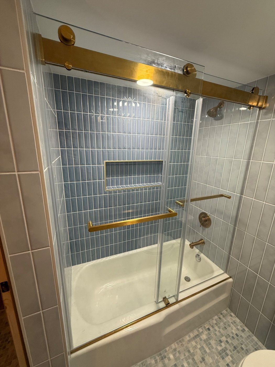 Closer view of the tub and glass door