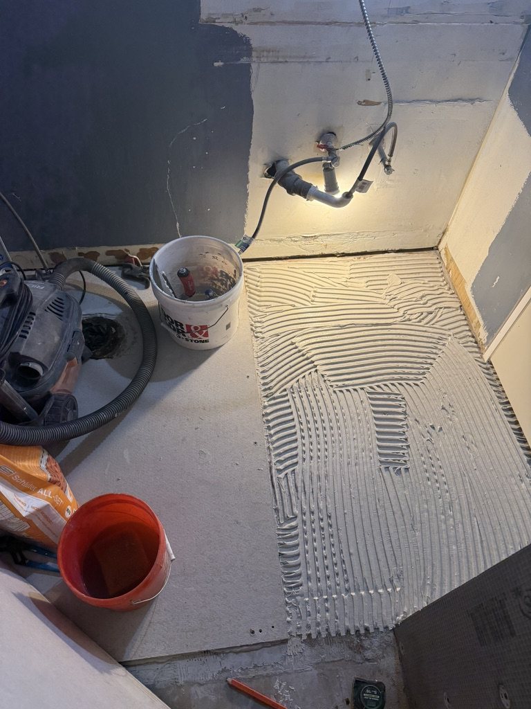 Shower floor mortar bed prep, second angle with plumbing rough-in
