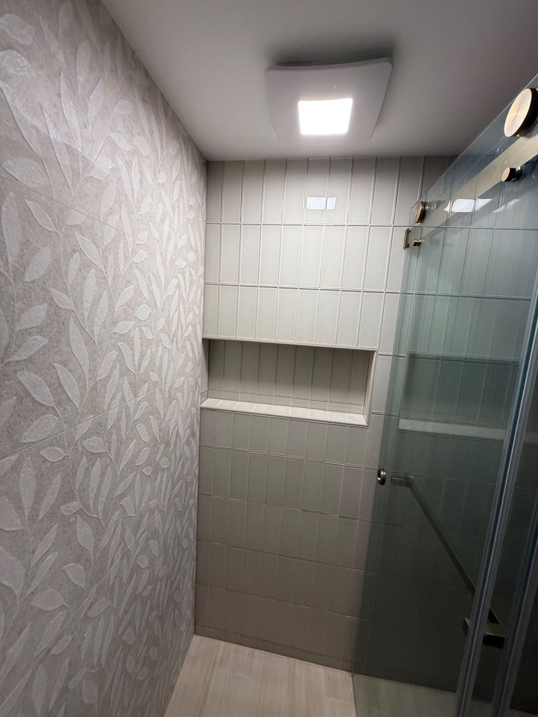 Toilet side with patterned feature wall and green vanity edge