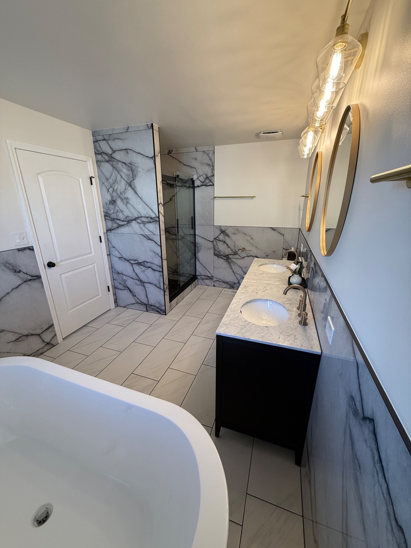 Bathroom remodel from the tub side toward the shower and vanity