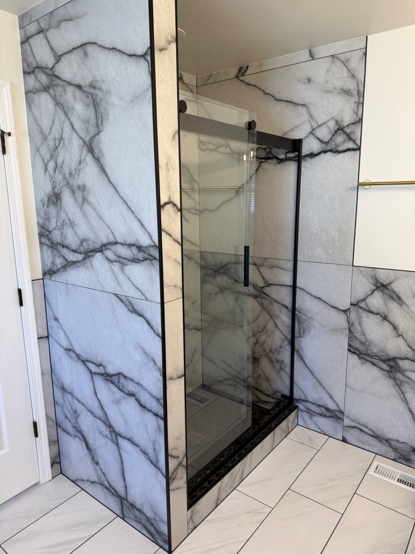 Shower entry and exterior marble-look wall detail