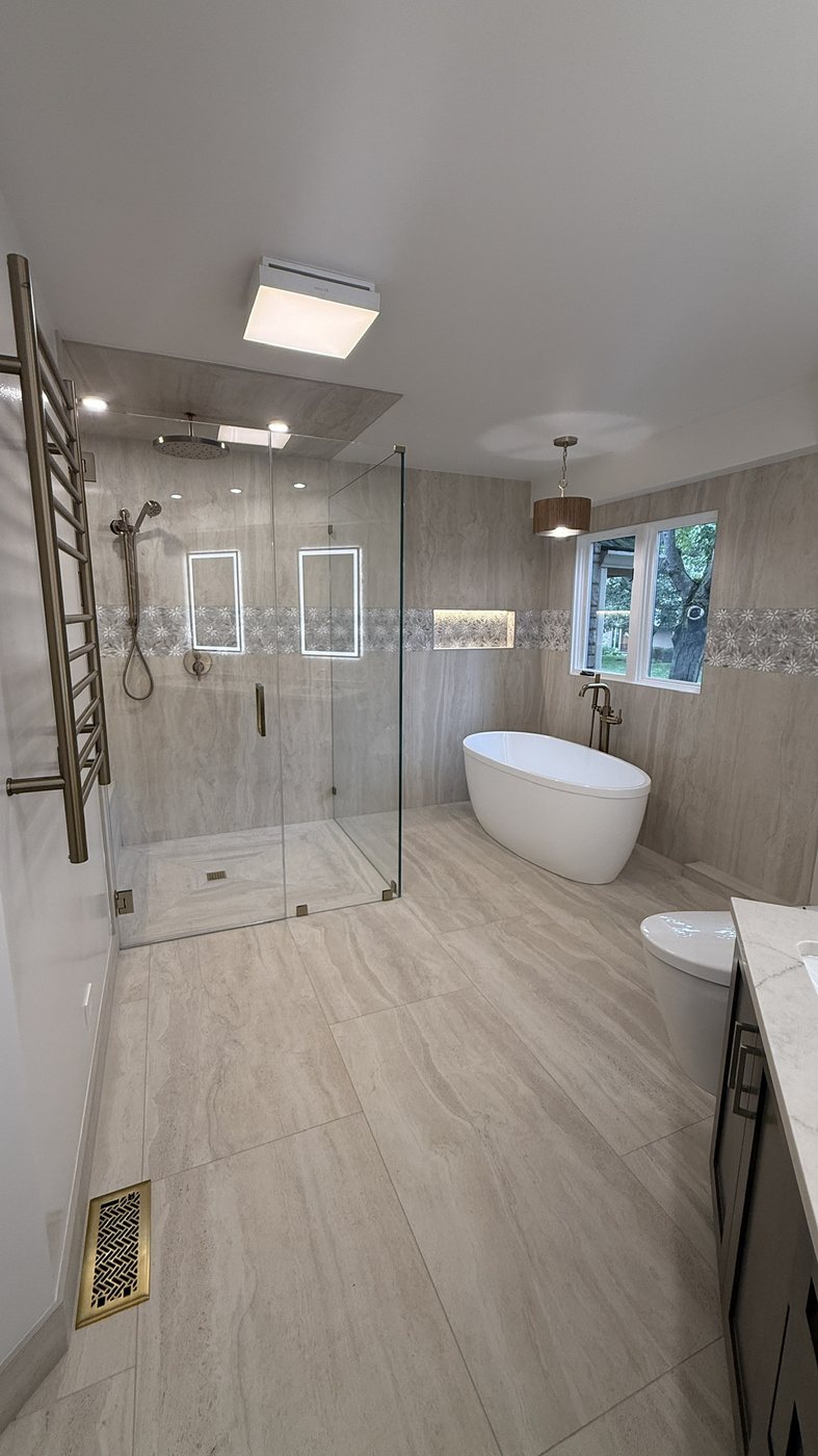 Finished spa-style primary bathroom remodel with rainfall shower and freestanding tub
