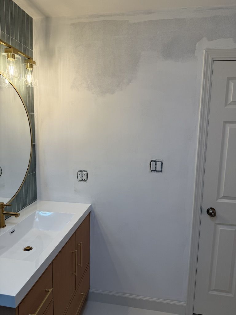 New vanity installed with primed wall waiting for wallpaper