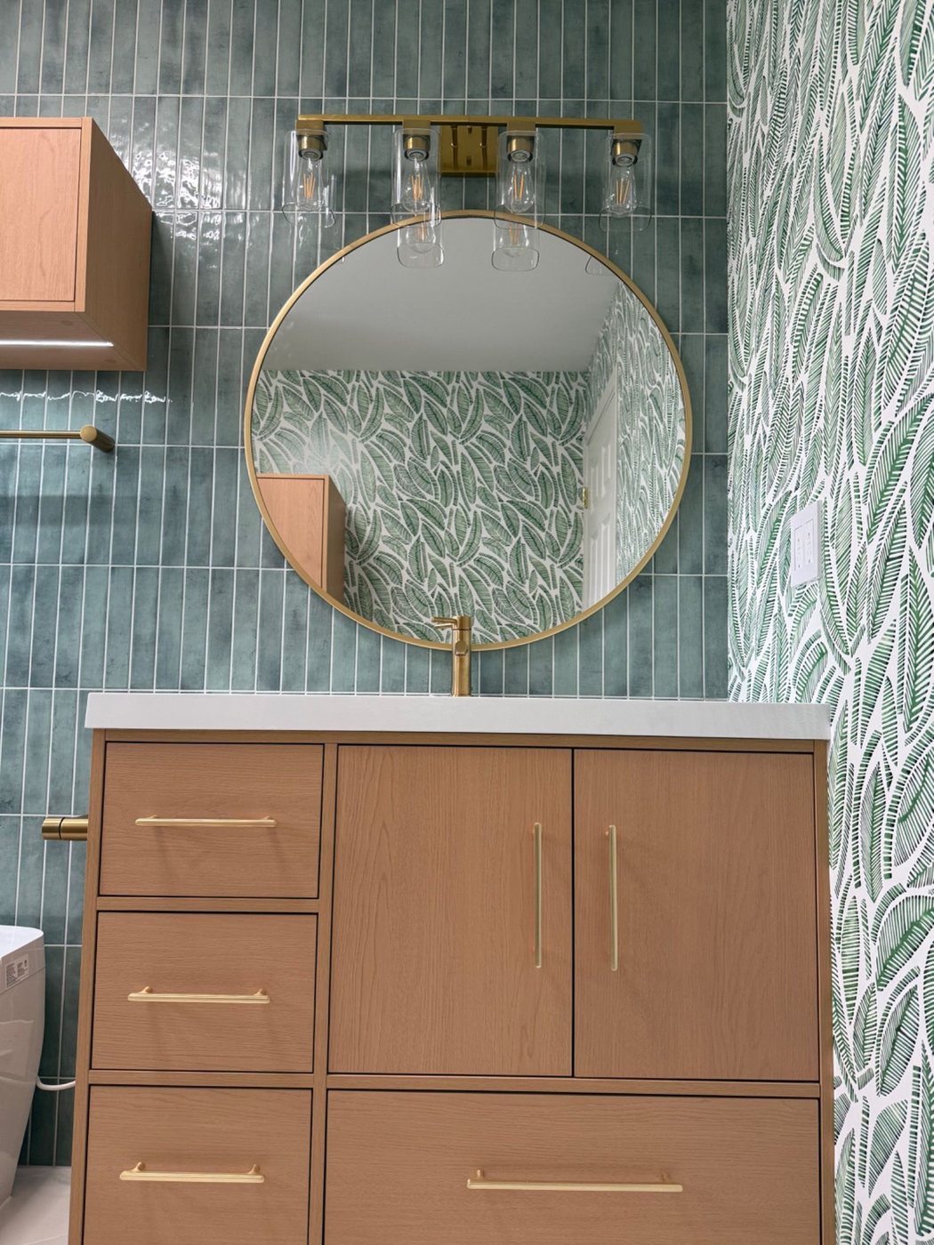 Mirror and light detail above vanity in tropical bathroom