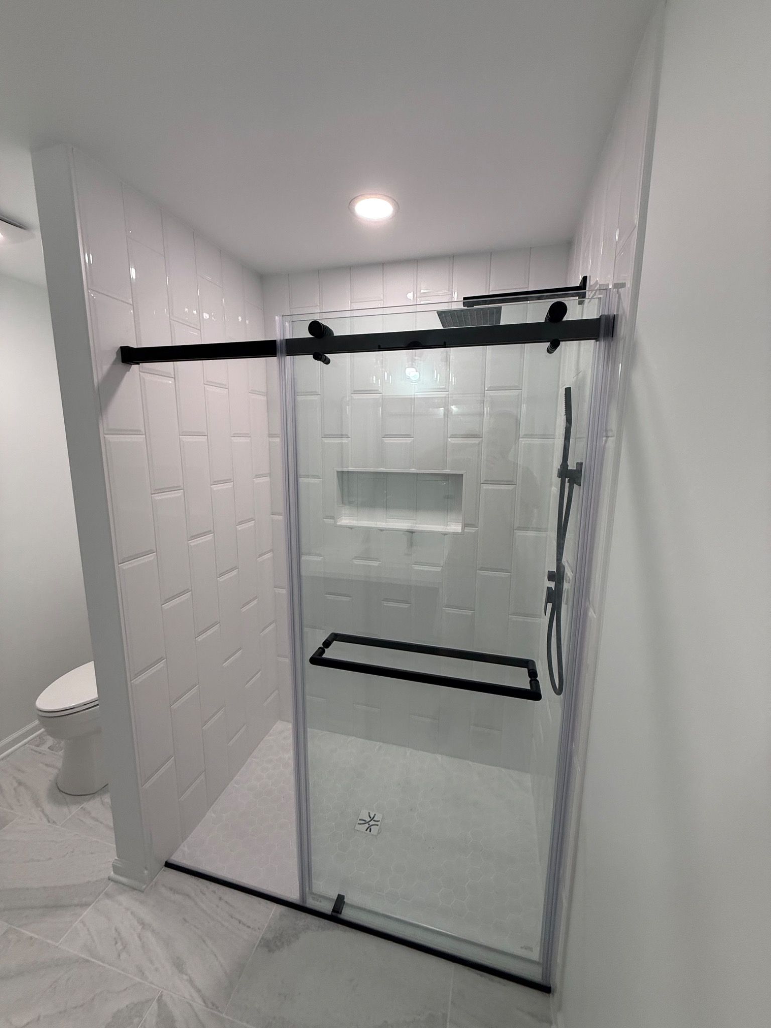 Glass shower with black hardware
