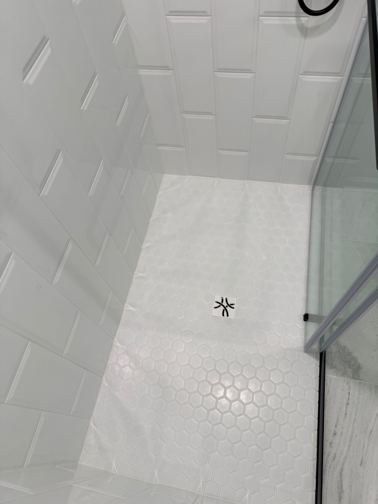 White hex shower floor tile detail