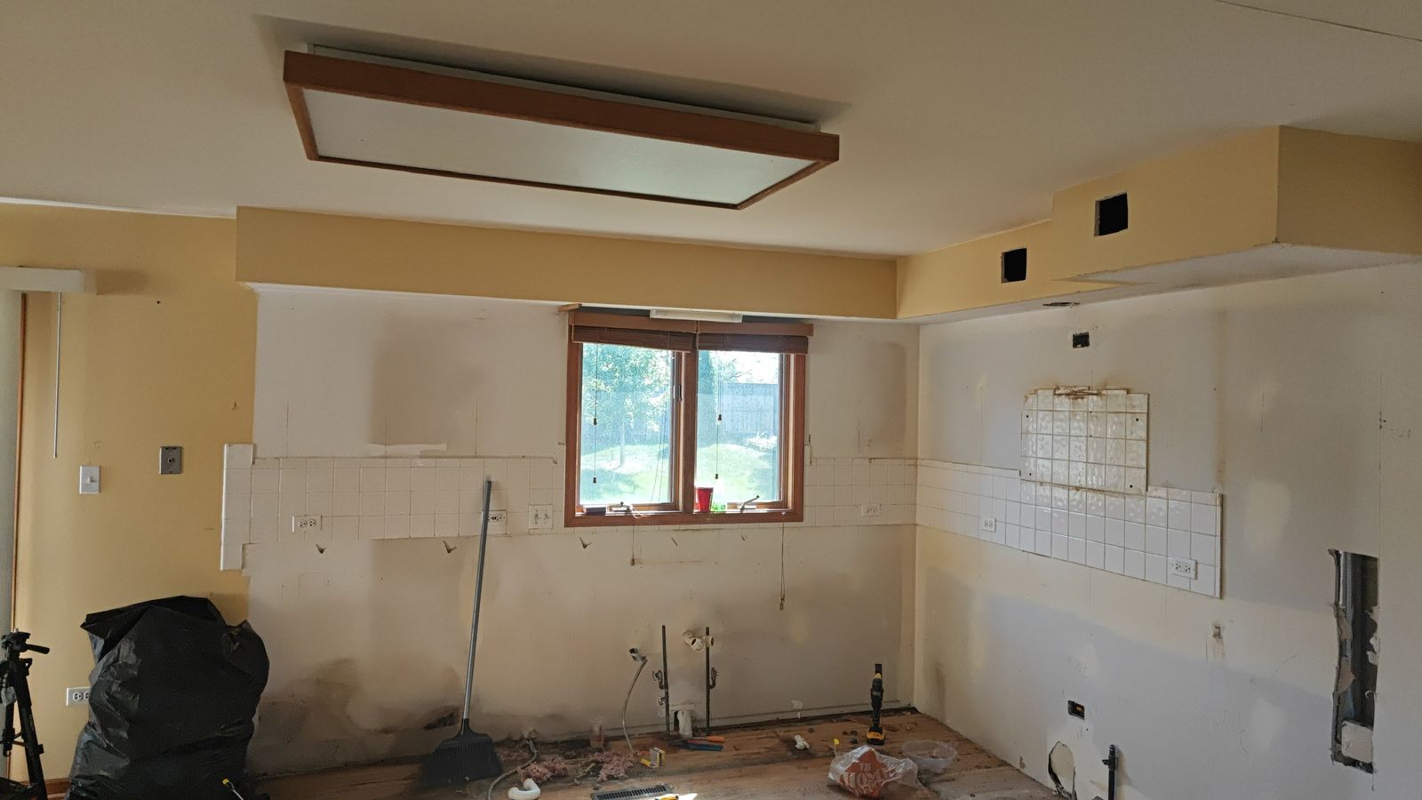 Demo stage: old tile backsplash and window before the remodel