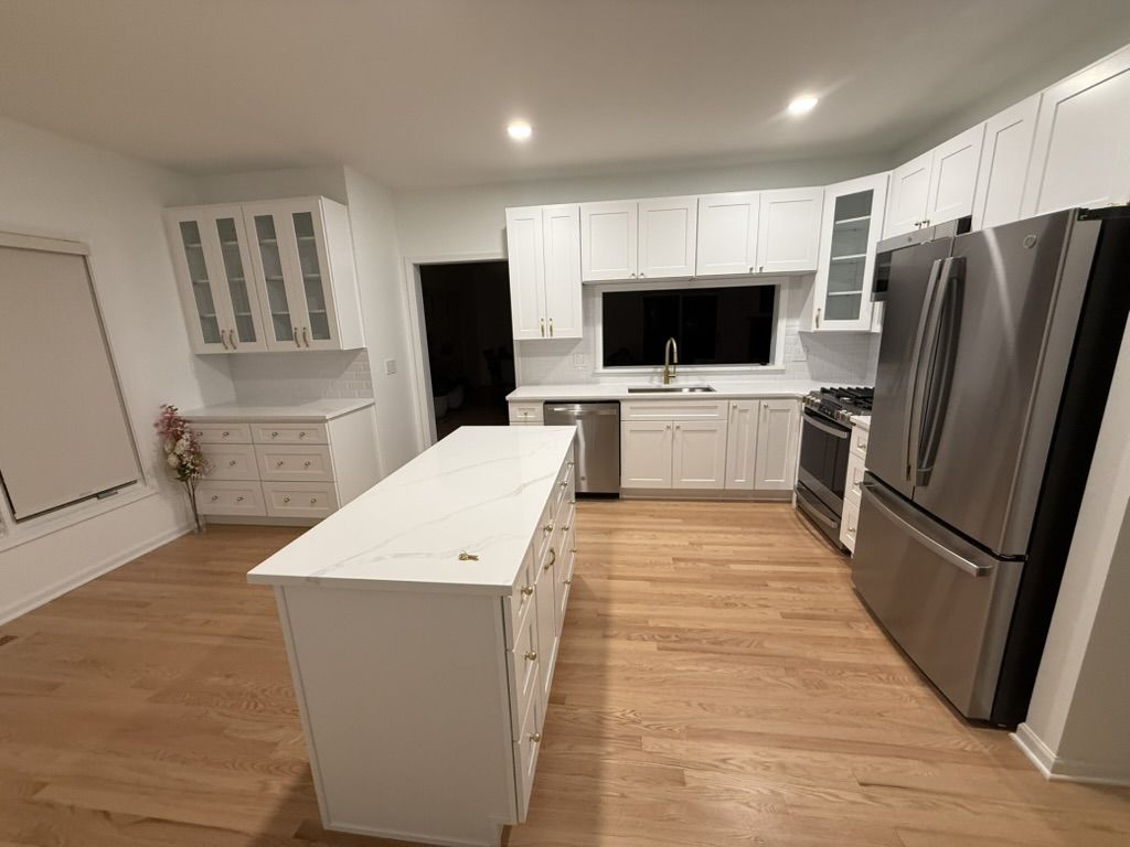 Wide overview of the finished kitchen with island and appliances
