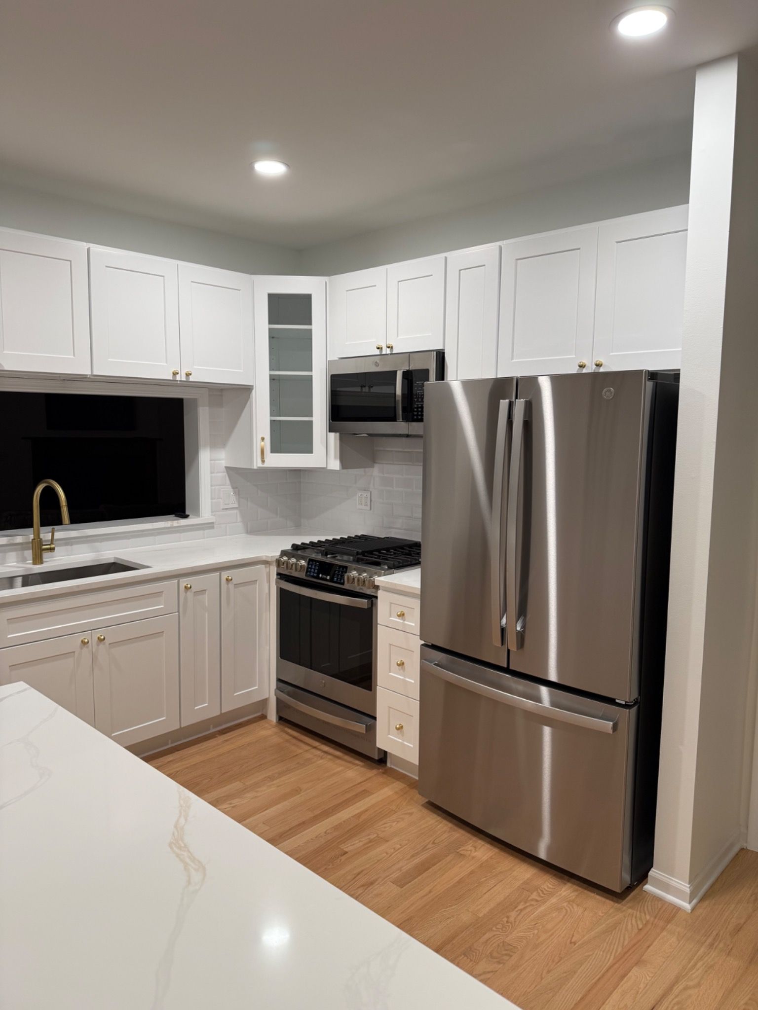 Kitchen view toward the range wall and refrigerator
