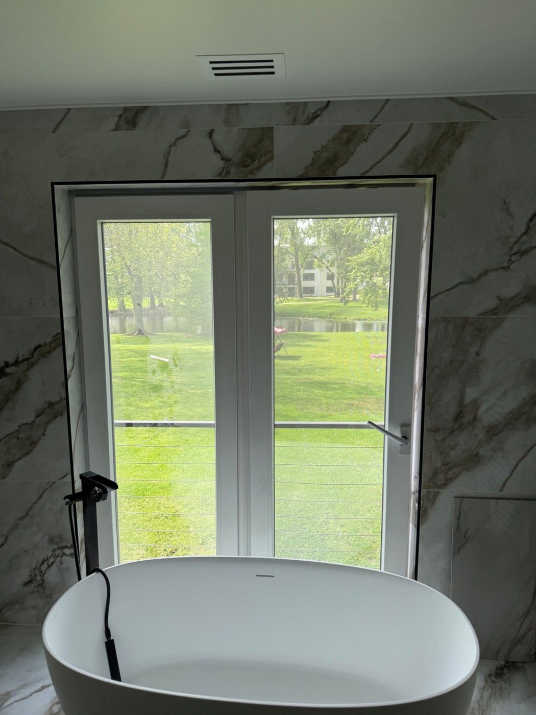 Tub area showing corrected tile work around a window return