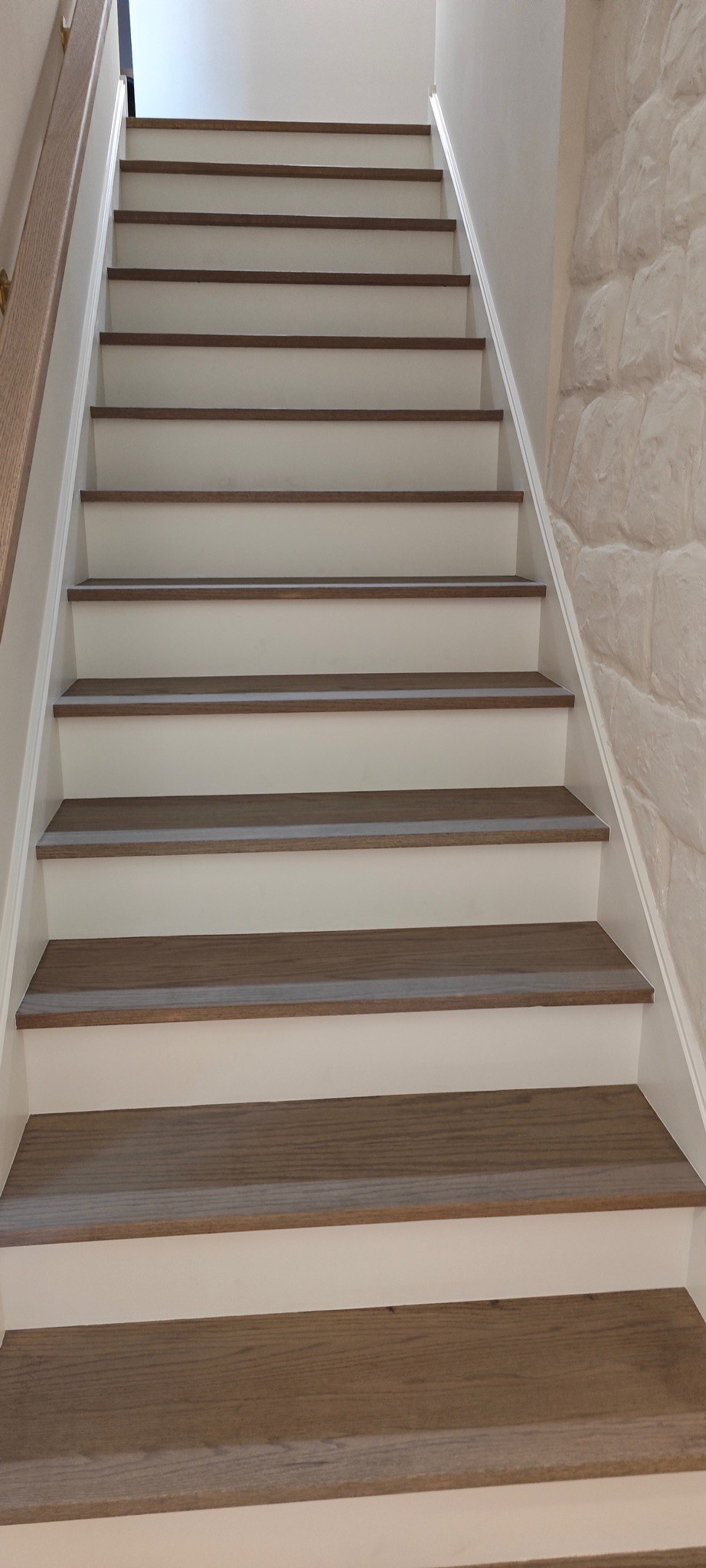 Staircase with painted white risers and dark stained treads