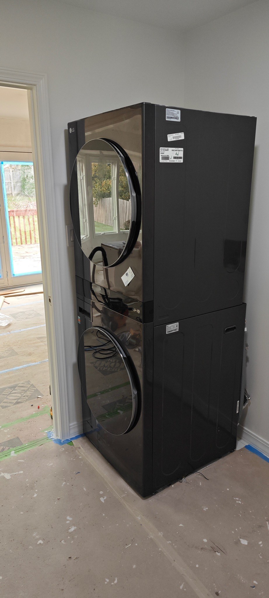 Stacked washer and dryer installed in laundry area